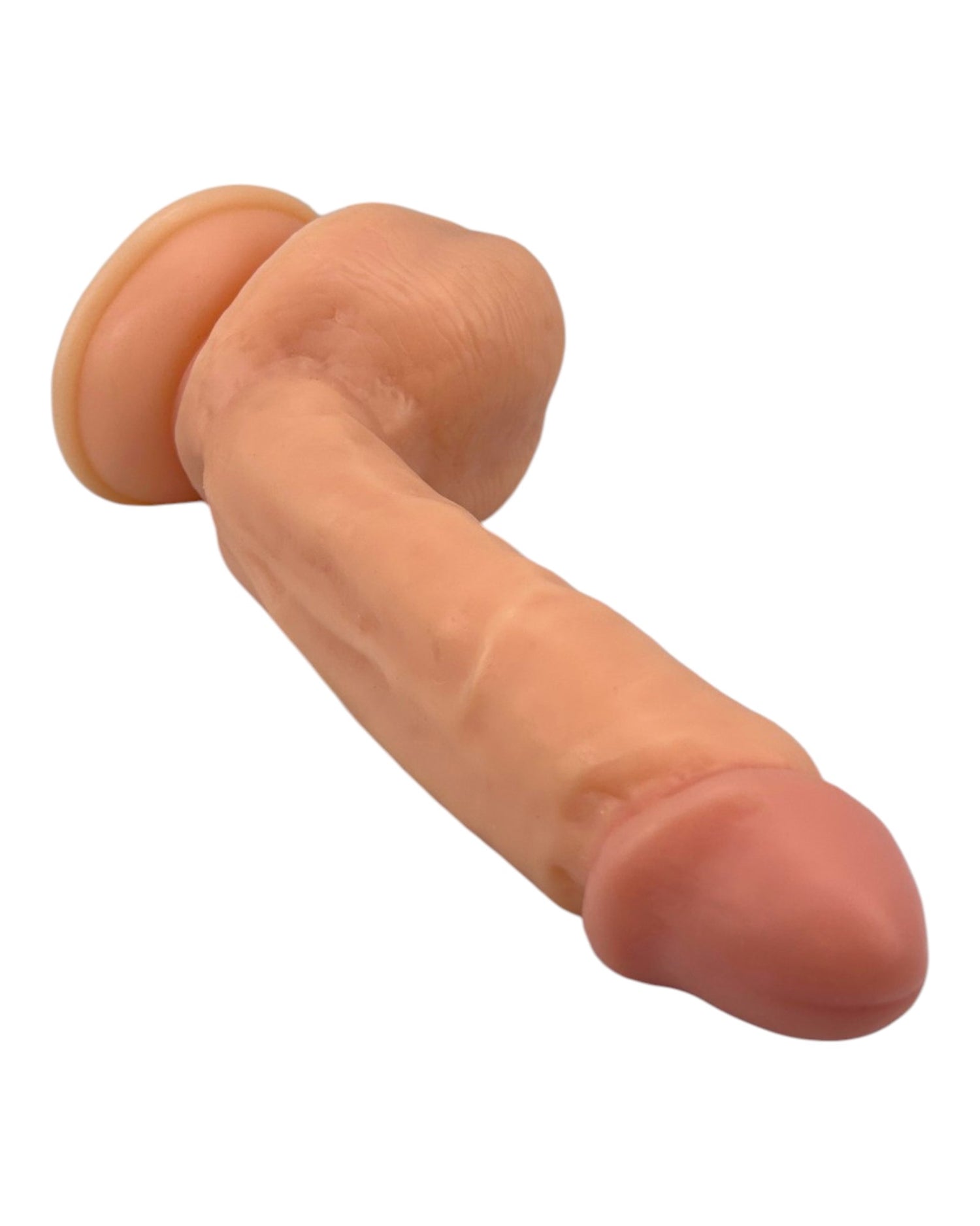 Dildo ultra realista Real King Magic Flesh con ventosa y testículos, textura suave y detallada, marca Glow & Vibe.