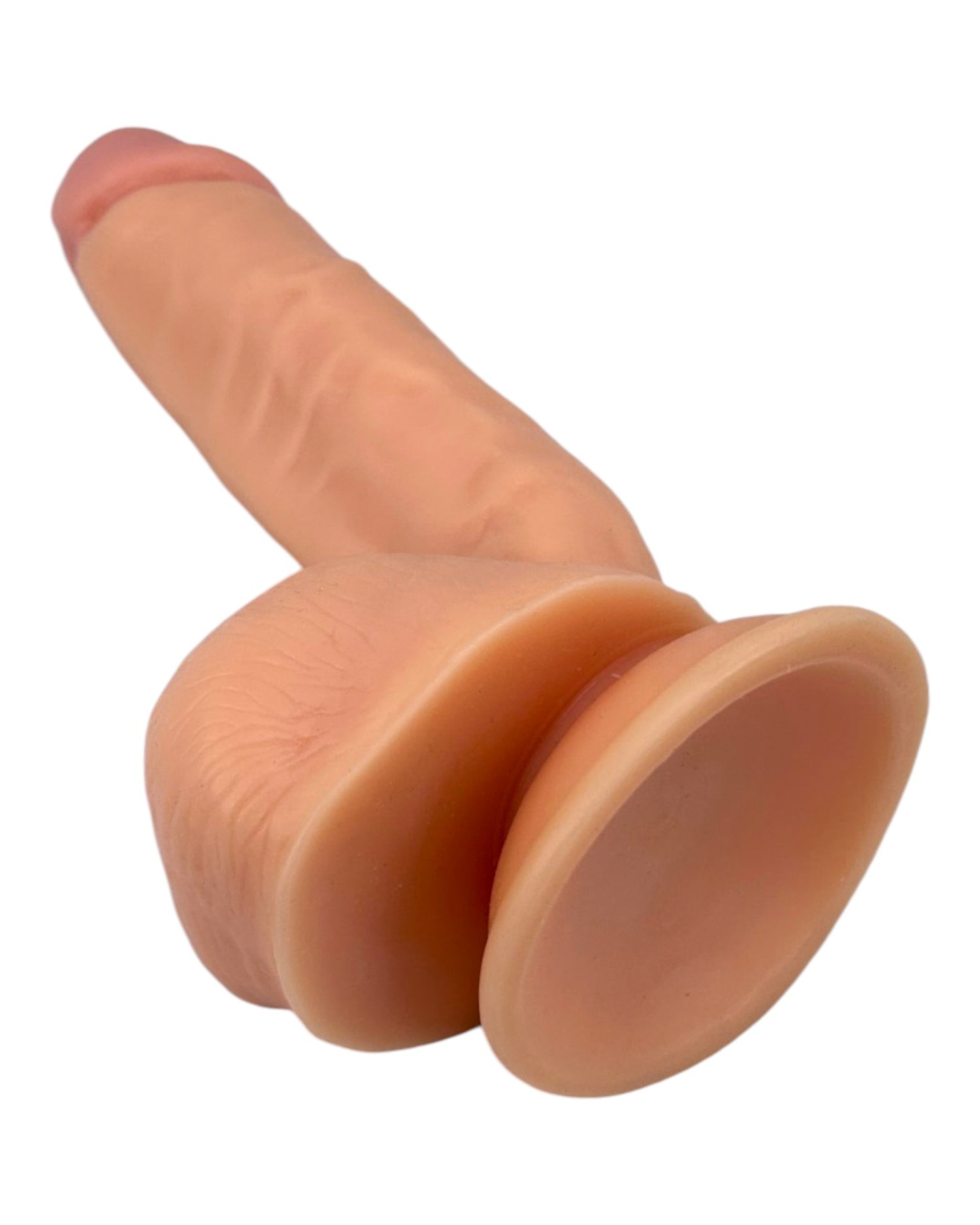 Dildo ultra realista Real King Magic Flesh con ventosa y testículos, textura suave y detallada, marca Glow & Vibe.