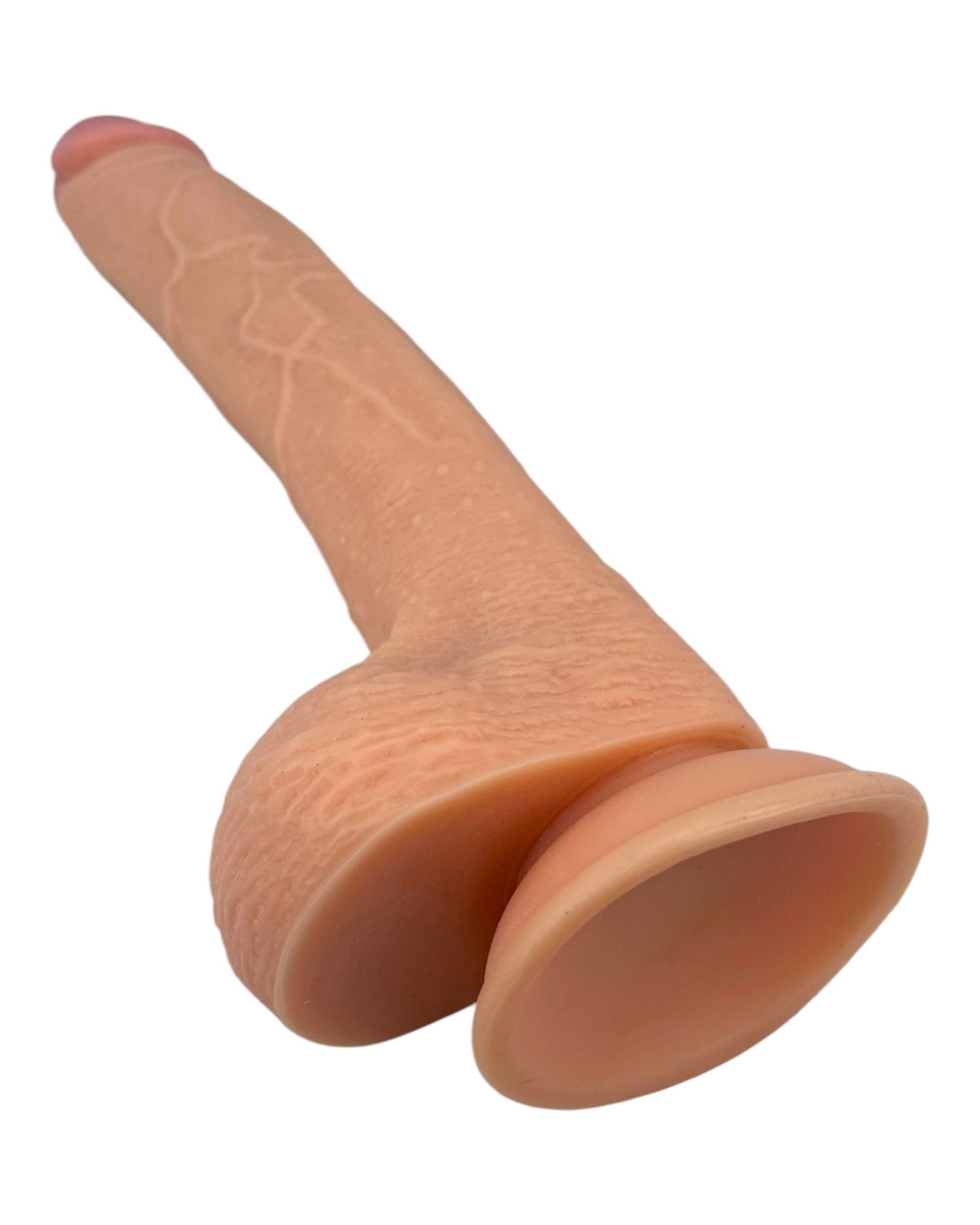 Dildo ultra realista Real King Magic Flesh con ventosa y testículos, textura suave y detallada, marca Glow & Vibe.