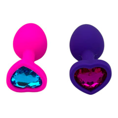 Plug anal Gema Bright de silicón suave con gema redonda, disponible en negro y rosa neón, diseño brillante de Glow & Vibe.