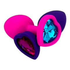 Plug anal Gema Bright de silicón suave con gema redonda, disponible en negro y rosa neón, diseño brillante de Glow & Vibe.