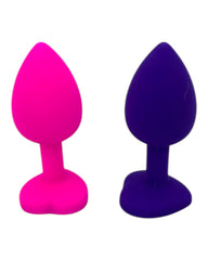 Plug anal Gema Bright de silicón suave con gema redonda, disponible en negro y rosa neón, diseño brillante de Glow & Vibe.