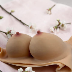 Prótesis de senos Soft Bust de silicón flexible con relleno de algodón, textura realista y diseño ergonómico Glow & Vibe.