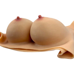 Prótesis de senos Soft Bust de silicón flexible con relleno de algodón, textura realista y diseño ergonómico Glow & Vibe.