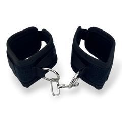 Glow & Vibe esposas de velcro negras con cadena metálica, ajustables y cómodas para juegos de sumisión.