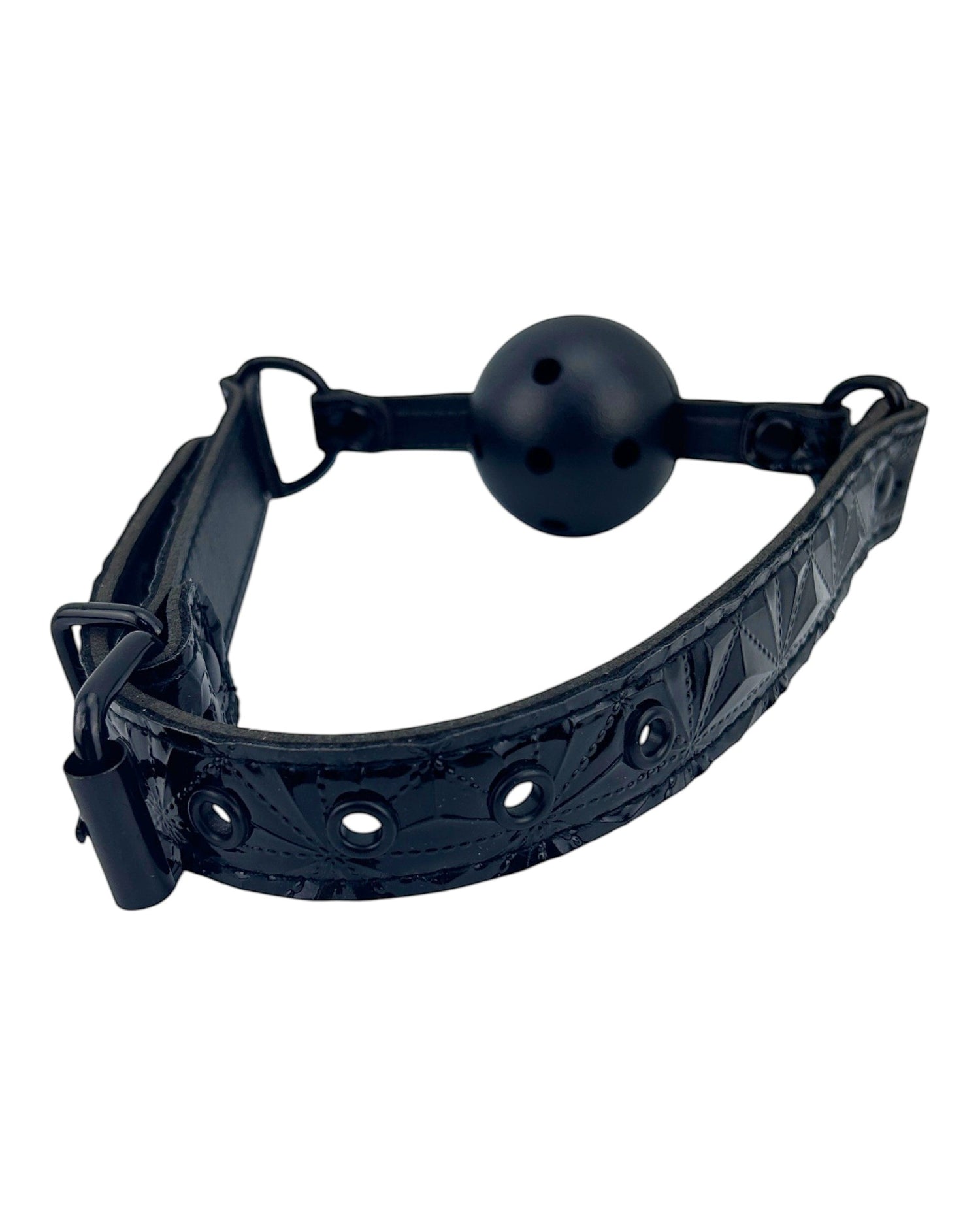 Mordaza bucal negra de Glow&Vibe con pelota rígida y cinturón de cuero sintético con detalles grabados.