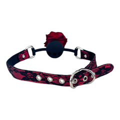 Glow & Vibe Rose Gag: mordaza bucal de silicona negra con rosa roja y cinturón de encaje rojo y negro ajustable.