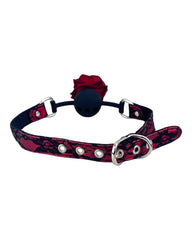 Glow & Vibe Rose Gag: mordaza bucal de silicona negra con rosa roja y cinturón de encaje rojo y negro ajustable.