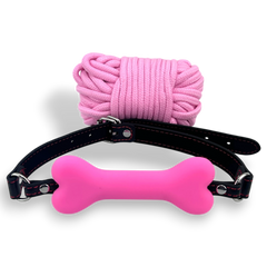 Glow&Vibe Shibari Bite Set: mordaza rosa con forma de hueso y cuerda de nylon rosa.