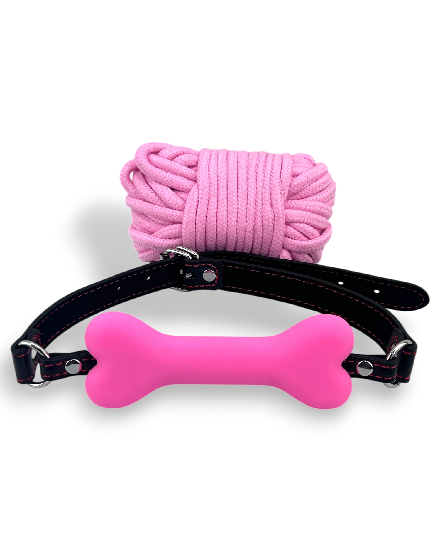 Glow&Vibe Shibari Bite Set: mordaza rosa con forma de hueso y cuerda de nylon rosa.