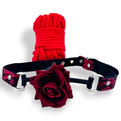 Glow&Vibe Shibari Rose Set: mordaza de silicona roja con rosa y cuerda de nylon roja.