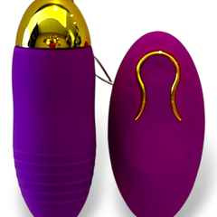 Bala vibradora inalámbrica Glow&Vibe color morado de silicón con detalles dorados y control remoto ergonómico